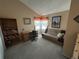 Cozy living room offers a comfortable seating area, a built-in bookshelf, and natural light from the window at 9535 W 104Th Ct, Broomfield, CO 80021