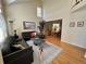 Bright living room boasts soaring ceilings, hardwood floors, and comfortable seating, bathed in natural light at 9535 W 104Th Ct, Broomfield, CO 80021
