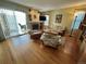 Comfortable living room with fireplace, hardwood floors, and sliding glass doors at 9535 W 104Th Ct, Broomfield, CO 80021