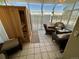 Bright sunroom with sauna, tile floors and wicker furniture at 9535 W 104Th Ct, Broomfield, CO 80021