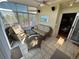 Bright sunroom featuring tile flooring, wicker furniture, and ample windows at 9535 W 104Th Ct, Broomfield, CO 80021