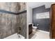 Bathroom featuring a combination shower and tub, modern tiling and a gray painted accent wall at 3225 Blake St # 6, Denver, CO 80205