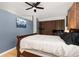 Bedroom featuring a brick accent wall, blue wall paint, and a ceiling fan at 3225 Blake St # 6, Denver, CO 80205