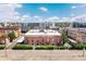 A charming red brick building, featuring multi-level balconies, green spaces, and classic architectural details at 3225 Blake St # 6, Denver, CO 80205