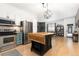Open kitchen featuring stainless appliances, kitchen island, and modern lighting fixtures at 3225 Blake St # 6, Denver, CO 80205