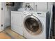 Well-equipped laundry room featuring a modern, white washer and dryer set for convenient laundry care at 3225 Blake St # 6, Denver, CO 80205