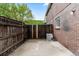 Private backyard featuring a new brick wall and an updated central air conditioning unit at 5667 S Lowell Blvd, Littleton, CO 80123