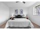Cozy bedroom with ceiling fan and large window and stylish decor at 5667 S Lowell Blvd, Littleton, CO 80123