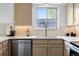 Updated kitchen featuring stainless steel appliances, quartz countertops, and a window view at 5667 S Lowell Blvd, Littleton, CO 80123