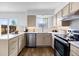 Kitchen featuring stainless steel appliances, quartz countertops, with a window view at 5667 S Lowell Blvd, Littleton, CO 80123