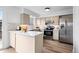 Updated kitchen featuring stainless steel appliances, quartz countertops, and ample cabinet space at 5667 S Lowell Blvd, Littleton, CO 80123