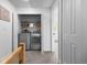Convenient laundry room featuring updated washer and dryer with built-in storage shelves at 5667 S Lowell Blvd, Littleton, CO 80123