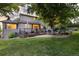 Spacious backyard featuring a large deck, mature trees, and a well-maintained lawn at 5506 Irish Pat Murphy Dr, Parker, CO 80134