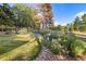 Lush backyard landscaping alongside a wooden fence at 5506 Irish Pat Murphy Dr, Parker, CO 80134