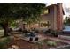 Inviting backyard with patio dining, deck seating, mature trees, and a relaxing hot tub at 5506 Irish Pat Murphy Dr, Parker, CO 80134