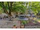 Relaxing backyard with mature trees, patio dining area, and a soothing hot tub at 5506 Irish Pat Murphy Dr, Parker, CO 80134
