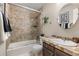 Bathroom with tile accents, a tub-shower, and a stylish sink with a decorative mirror at 5506 Irish Pat Murphy Dr, Parker, CO 80134