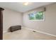 Cozy bedroom with a window, neutral walls, carpet, and a storage bench at 5506 Irish Pat Murphy Dr, Parker, CO 80134