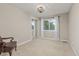 Bright bedroom featuring neutral walls, carpet, a large window, and mirrored closet doors at 5506 Irish Pat Murphy Dr, Parker, CO 80134