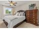 Comfortable bedroom with a cozy bed, dresser, and soft natural light from a window at 5506 Irish Pat Murphy Dr, Parker, CO 80134
