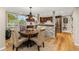 Dining area features an elegant chandelier, round table, and convenient access to the kitchen with stone accents at 5506 Irish Pat Murphy Dr, Parker, CO 80134