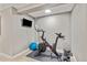 Home exercise area featuring a stationary bike, weights, and a mounted television at 5506 Irish Pat Murphy Dr, Parker, CO 80134