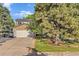 Beautiful home with a two-car garage, mature trees, and a well-groomed lawn on a sunny day at 5506 Irish Pat Murphy Dr, Parker, CO 80134