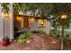 Inviting front entrance with a stylish wood door, brick pathway, decorative lighting, and manicured landscaping at 5506 Irish Pat Murphy Dr, Parker, CO 80134