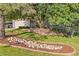 Landscaped front yard showcasing a rock garden, mature trees, retaining wall, and lush lawn at 5506 Irish Pat Murphy Dr, Parker, CO 80134