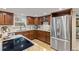 Modern kitchen with stainless steel refrigerator, granite countertops, updated appliances, and ample cabinet space at 5506 Irish Pat Murphy Dr, Parker, CO 80134