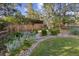 Beautifully landscaped backyard with stone walkways, lush greenery, and a peaceful ambiance at 5506 Irish Pat Murphy Dr, Parker, CO 80134