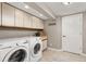 Functional laundry room with washer, dryer, storage cabinets and natural light at 5506 Irish Pat Murphy Dr, Parker, CO 80134