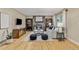 Comfortable living room featuring hardwood floors, a cozy fireplace, built-in bookshelves, and stylish furniture at 5506 Irish Pat Murphy Dr, Parker, CO 80134