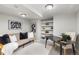 Modern living room area with a sofa, desk, shelving, and decorative artwork at 5506 Irish Pat Murphy Dr, Parker, CO 80134