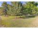 Expansive lawn featuring mature trees, manicured landscaping, and plenty of space for outdoor activities at 5506 Irish Pat Murphy Dr, Parker, CO 80134