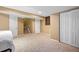 Spacious basement featuring neutral carpeting, access to stairs and multiple doors at 1464 Spotted Owl Way, Highlands Ranch, CO 80129
