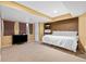 Basement with carpeted floors, a tv, and a queen size bed with white linens at 1464 Spotted Owl Way, Highlands Ranch, CO 80129