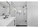 Bathroom featuring a glass-enclosed shower, a modern vanity, and white subway tiles at 1464 Spotted Owl Way, Highlands Ranch, CO 80129