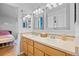 Shared bathroom with double sinks, and a view into an adjacent bedroom at 1464 Spotted Owl Way, Highlands Ranch, CO 80129