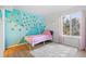 Cozy bedroom with colorful decor and a large window with lots of natural light at 1464 Spotted Owl Way, Highlands Ranch, CO 80129