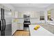 Bright kitchen featuring stainless steel appliances, white cabinets, and hardwood floors at 1464 Spotted Owl Way, Highlands Ranch, CO 80129