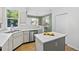 Modern kitchen with stainless steel appliances, white countertops, and a bright window overlooking the backyard at 1464 Spotted Owl Way, Highlands Ranch, CO 80129