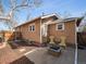 Backyard featuring a fire pit, chairs, patio, and mature tree at 6940 W 48Th Ave, Wheat Ridge, CO 80033