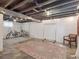 Exposed basement with concrete floor and ceiling, rugs and bikes at 6940 W 48Th Ave, Wheat Ridge, CO 80033