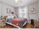 Bright bedroom featuring a ceiling fan, light-colored walls, and hardwood flooring at 6940 W 48Th Ave, Wheat Ridge, CO 80033