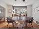 Inviting dining room featuring hardwood floors, stylish chairs and a window seat with natural light at 6940 W 48Th Ave, Wheat Ridge, CO 80033