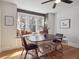 Elegant dining room with a window seat, modern lighting, and stylish transparent chairs at 6940 W 48Th Ave, Wheat Ridge, CO 80033