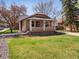 Charming home with a well-manicured lawn featuring a cozy front porch and inviting curb appeal at 6940 W 48Th Ave, Wheat Ridge, CO 80033