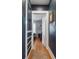 Hallway leading to a bedroom with hardwood floors and custom built in storage at 6940 W 48Th Ave, Wheat Ridge, CO 80033