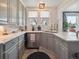 Bright kitchen with gray cabinets, marble countertops, stainless steel appliances, and modern fixtures at 6940 W 48Th Ave, Wheat Ridge, CO 80033